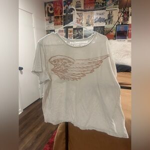 Magnolia Pearl Cream T-Shirt with Brown Wing Design